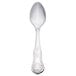 A Libbey stainless steel dessert spoon with a design on the handle.