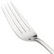 A close-up of a Chef & Sommelier stainless steel dinner fork with a white handle.