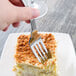 A Libbey stainless steel dinner fork on a piece of cake.