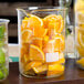 An American Metalcraft beaker glass filled with orange and lemon slices.