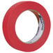 A roll of Duck Tape red masking tape with the word "tape" on it.