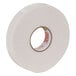 A roll of white Duck brand foam mounting tape with a white adhesive.