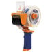 A Duck Tape dispenser with an orange and blue plastic card holder and a circle on it.