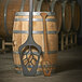 A wooden Epicurean Richlite wood fiber mash paddle on a wine barrel.