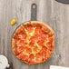 A pepperoni pizza on an Epicurean wood pizza board.