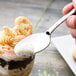 A Libbey stainless steel dessert spoon holding a dessert with ice cream.