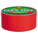 A roll of red Duck Tape with a green and red label.