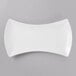 A Schonwald white porcelain bowtie tray with a curved edge.