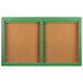 A green framed Aarco indoor enclosed bulletin board with two doors.