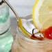 A Chef & Sommelier iced tea spoon in a glass jar of liquid.