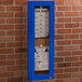 An Aarco blue indoor bulletin board cabinet with a menu inside.
