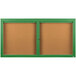 A brown bulletin board cabinet with green frame and two enclosed green bulletin boards with two doors.