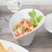 A white Schonwald Calla bowl with food on a table.
