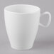 A close-up of a Schonwald white porcelain cup with a handle.
