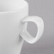 A close-up of a Schonwald white porcelain espresso cup with a handle.