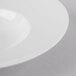 A Schonwald Grace white porcelain bowl with a white rim on a white surface.