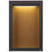 A brown cabinet with a light inside and a cork board.