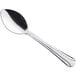 A Choice Dominion stainless steel demitasse spoon with a silver handle.