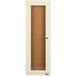 An ivory rectangular cabinet with a glass door enclosing a cork board.