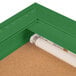 A green indoor bulletin board cabinet with a white tube inside.
