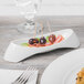 A white Schonwald porcelain plate with food on it.
