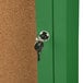 A green Aarco indoor bulletin board cabinet with a key in the lock.