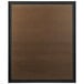 A brown rectangular Aarco bulletin board with a black frame.