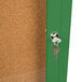 An Aarco green indoor bulletin board cabinet with a key in the door.
