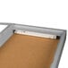 An Aarco satin anodized indoor lighted bulletin board cabinet with 1 door.
