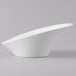 A close-up of a Schonwald Grace white porcelain Calla bowl with a curved shape.