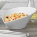 A close-up of a Schonwald Grace white porcelain bowl filled with pasta.