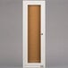 A white rectangular door with a glass panel enclosing a cork bulletin board.