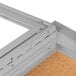 An Aarco satin anodized metal frame enclosed bulletin board with cork.