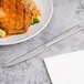 A plate of meat and rice with vegetables and an Arcoroc stainless steel steak knife.