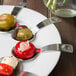 A Schonwald porcelain tapas plate with spoons filled with different colored food.