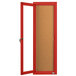 A red enclosed door with a cork board inside.