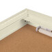 A white indoor bulletin board cabinet with a light.