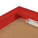 A red corner bulletin board cabinet with a white light inside.