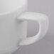 A close-up of a Schonwald white porcelain espresso cup with a handle.