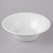 A Schonwald Avanti Gusto white bowl with a white rim on a gray surface.