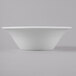 A Schonwald Avanti Gusto white porcelain bowl on a gray surface.