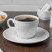 A Schonwald porcelain saucer with a cup of coffee on a table.