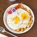 A Schonwald continental white porcelain bowl with eggs and flowers on it.