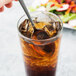 A Libbey stainless steel iced tea spoon in a glass of iced tea.