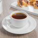 A Schonwald Avanti Gusto espresso saucer with a cup of coffee on a table.