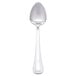 A Libbey stainless steel dessert spoon with a white handle.