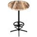 A round wooden table with a wooden bar height base.