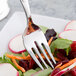 A Libbey stainless steel salad fork in a bowl of vegetables.