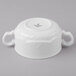 A close up of a white Schonwald porcelain bowl with two handles.