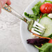 A Master's Gauge stainless steel fork on a plate of salad.